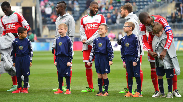 PHOTOS: Revs offer up their coats to walkout kids on a chilly day in Philly -