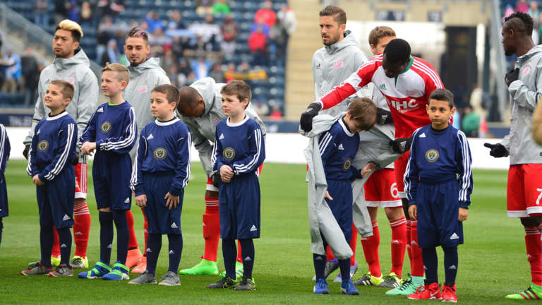 PHOTOS: Revs offer up their coats to walkout kids on a chilly day in Philly -