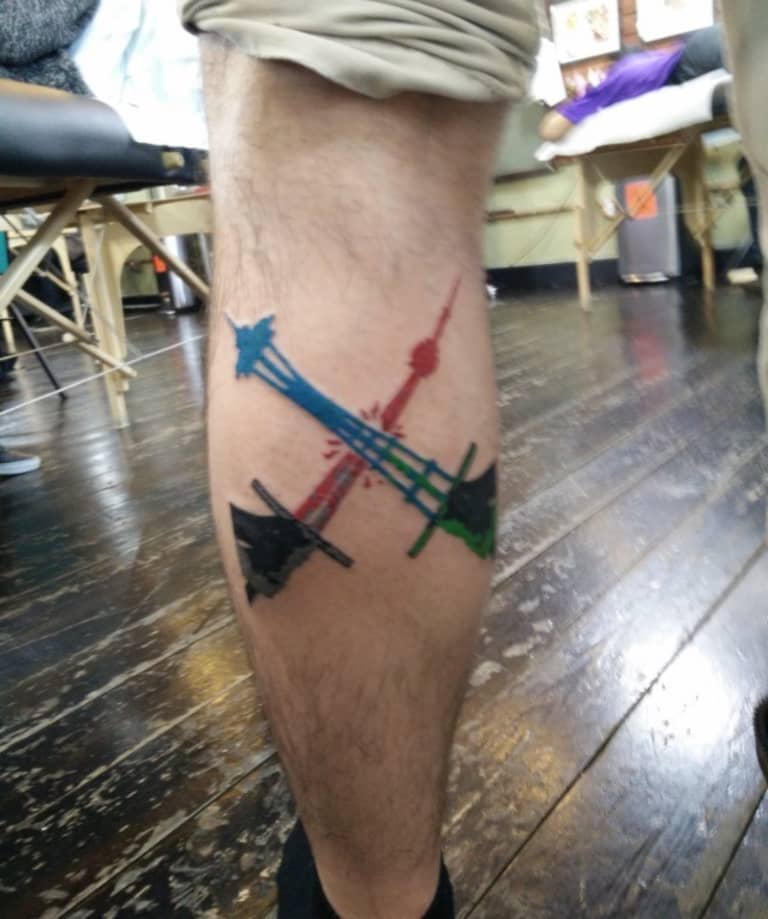 Seattle Sounders fan tattoos MLS Cup “Posters by the People” design on his leg -