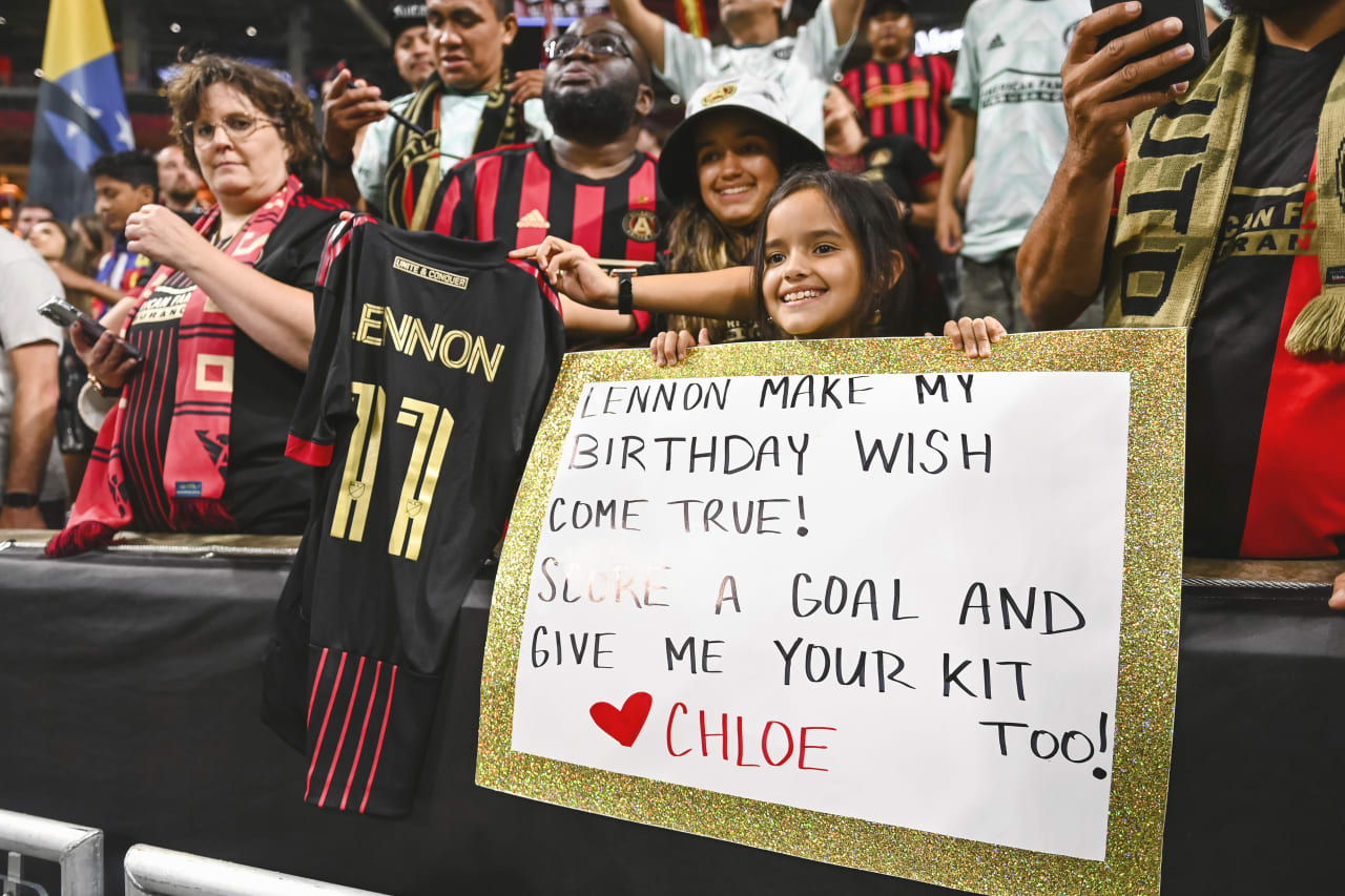 Atlanta United defender Brooks Lennon #11 gives a supporter his jersey after the match against New York Red Bulls at Mercedes-Benz Stadium in Atlanta, United States on Wednesday August 17, 2022. (Photo by Jay Bendlin/Atlanta United)