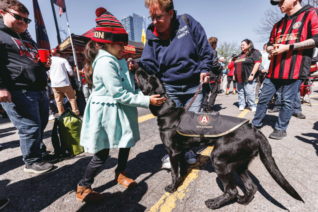 Atlanta United supporters pet King before the match against Charlotte FC at Bank of America Stadium in Charlotte, United States on Sunday April 10, 2022. (Photo by Karl Moore/Atlanta United)