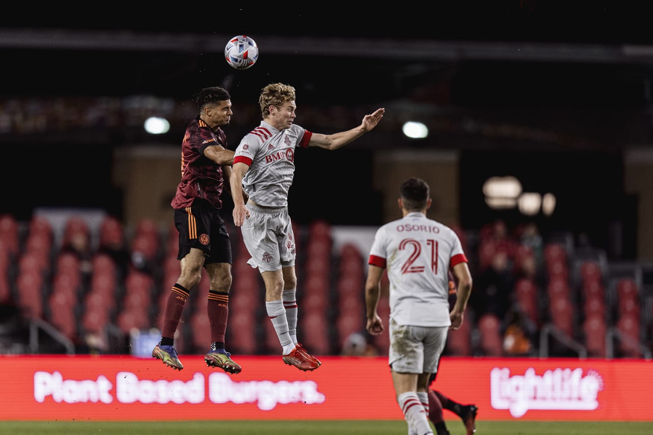 Atlanta United defender Miles Robinson #12 goes up for the ball during the match against Toronto FC at BMO Training Ground in Toronto, Ontario on Saturday October 16, 2021. (Photo by Jacob Gonzalez/Atlanta United)
