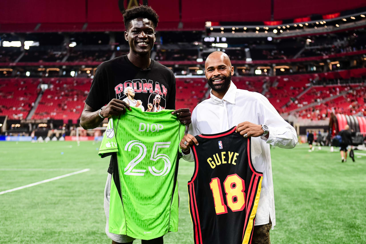 Atlanta United goalkeeper Clement Diop #25 and Atlanta Hawks rookie Mouhamed Gueye jersey swap prior to the match against Philadelphia Union at Mercedes-Benz Stadium in Atlanta, GA on Sunday, July 2, 2023. (Photo by Kyle Hess/Atlanta United)