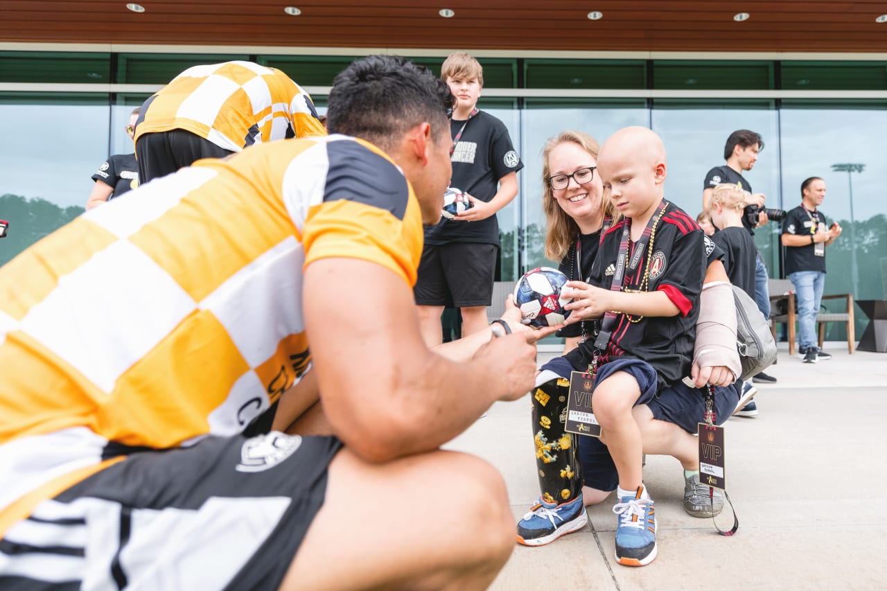 Atlanta United players sign soccer balls for Owen Klemme Conquer Kids participants after training at Children's Healthcare of Atlanta Training Ground in Marietta, Georgia, on Wednesday August 24, 2022. (Photo by Dakota Williams/Atlanta United)