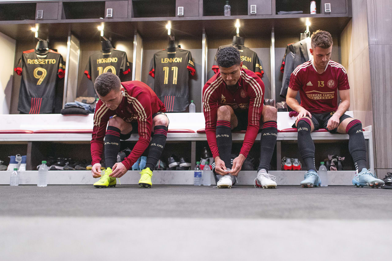Atlanta United defender Brooks Lennon #11, defender Miles Robinson #12 and midfielder Amar Sejdic #13 prepare in the locker room before the 2022 Opening Day match against Sporting Kansas City at Mercedes-Benz Stadium in Atlanta, United States on Sunday February 27, 2022. (Photo by Jacob Gonzalez/Atlanta United)