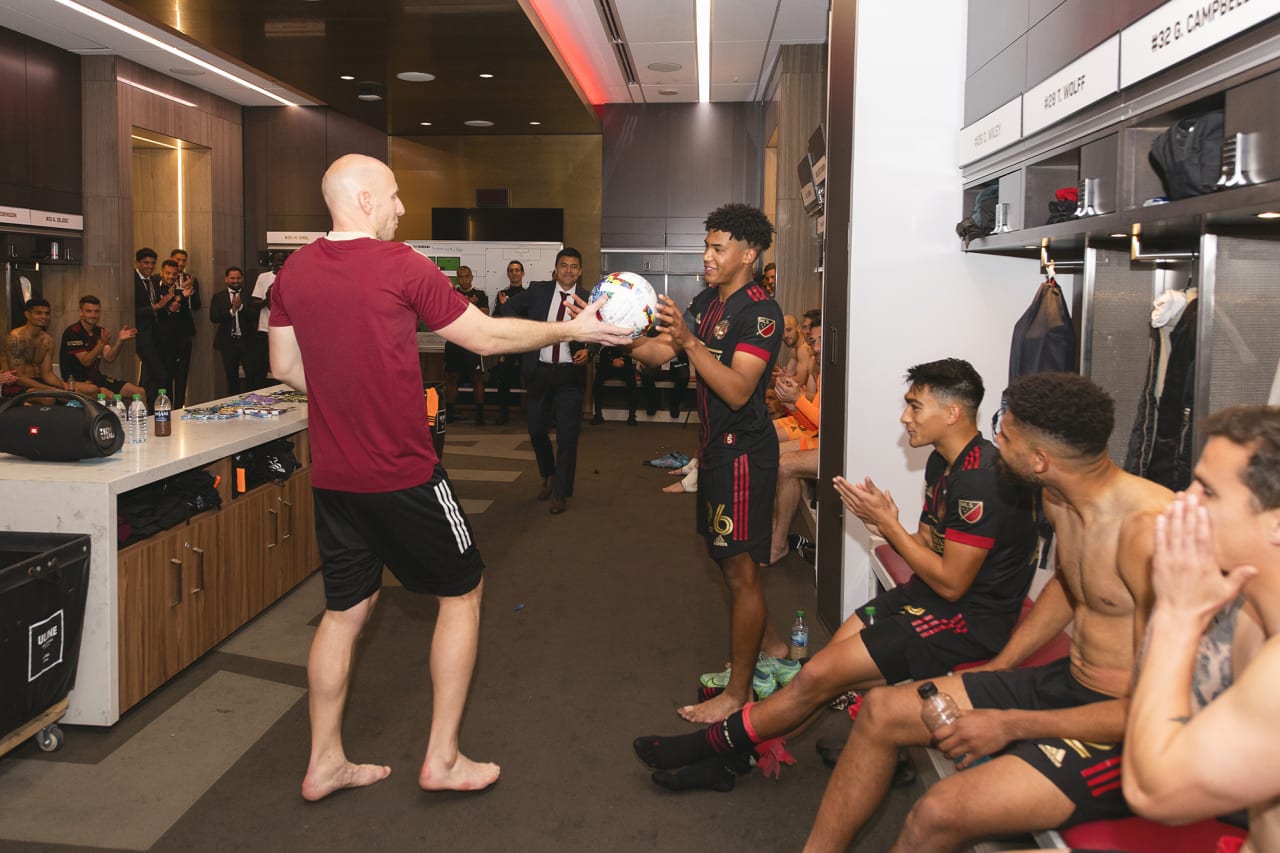 Atlanta United goalkeeper Brad Guzan #1 presents the game ball to defender Caleb Wiley #26 after the 2022 Opening Day match against Sporting Kansas City at Mercedes-Benz Stadium in Atlanta, United States on Sunday February 27, 2022. (Photo by Jacob Gonzalez/Atlanta United)
