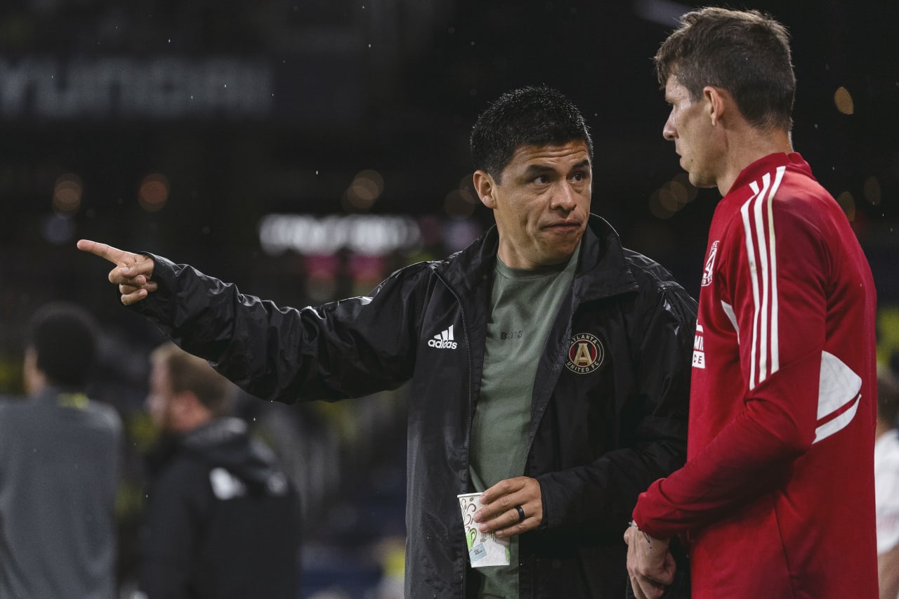 Atlanta United Head Coach Gonzalo Pineda talks with goalkeeper Bobby Shuttleworth #18 after a weather delay during the match against Nashville SC at Nashville SC Stadium in Nashville, United States on Saturday May 21, 2022. (Photo by Dakota Williams/Atlanta United)
