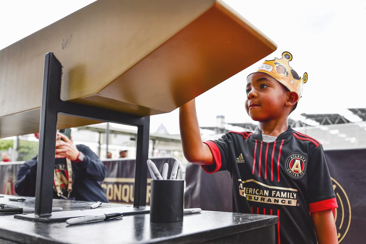 Atlanta United supporters sign the golden spike before  the match against New York Red Bulls at Mercedes-Benz Stadium in Atlanta, United States on Wednesday August 17, 2022. (Photo by Kyle Hess/Atlanta United)
