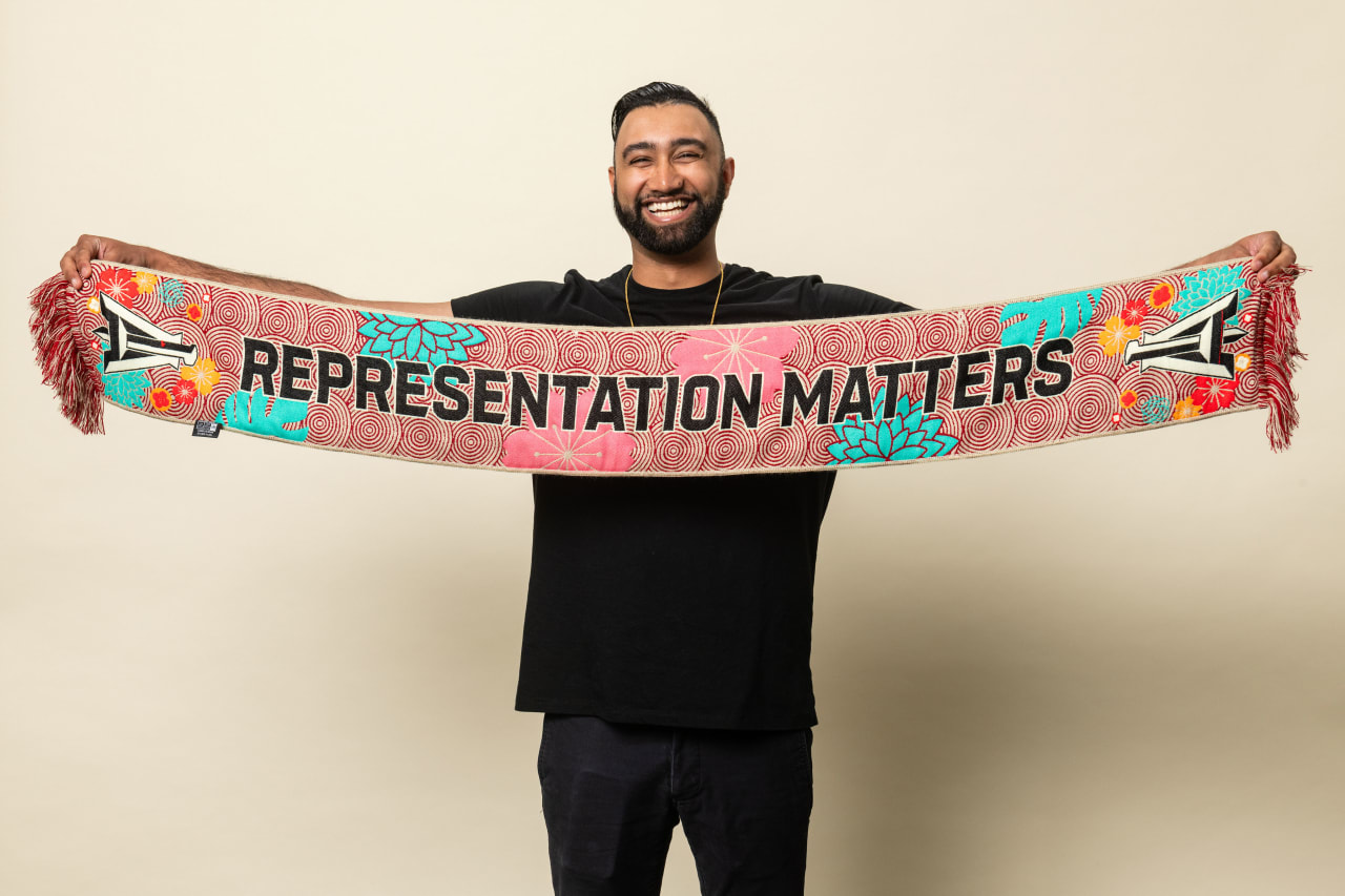 Atlanta United staff member models May Scarf of the Month on Tuesday, April 25, 2023.