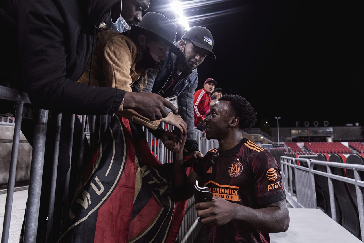 Atlanta United defender George Bello #21 high fives supporters after the match against Toronto FC at BMO Training Ground in Toronto, Ontario on Saturday October 16, 2021. (Photo by Jacob Gonzalez/Atlanta United)