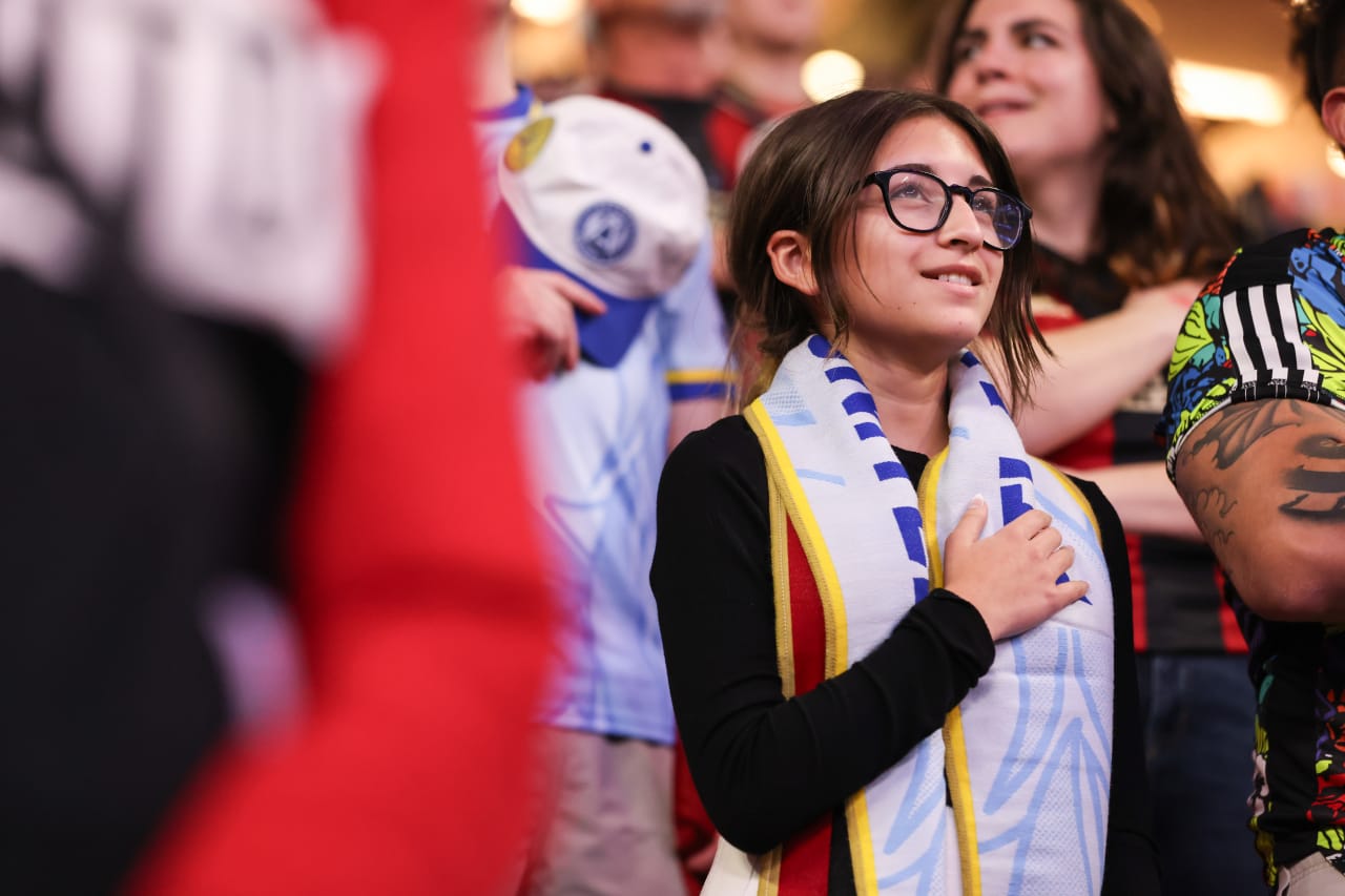 A supporter stands for the national anthem before the match against New England Revolution at Mercedes-Benz Stadium in Atlanta, Ga. On Saturday, March 9, 2024