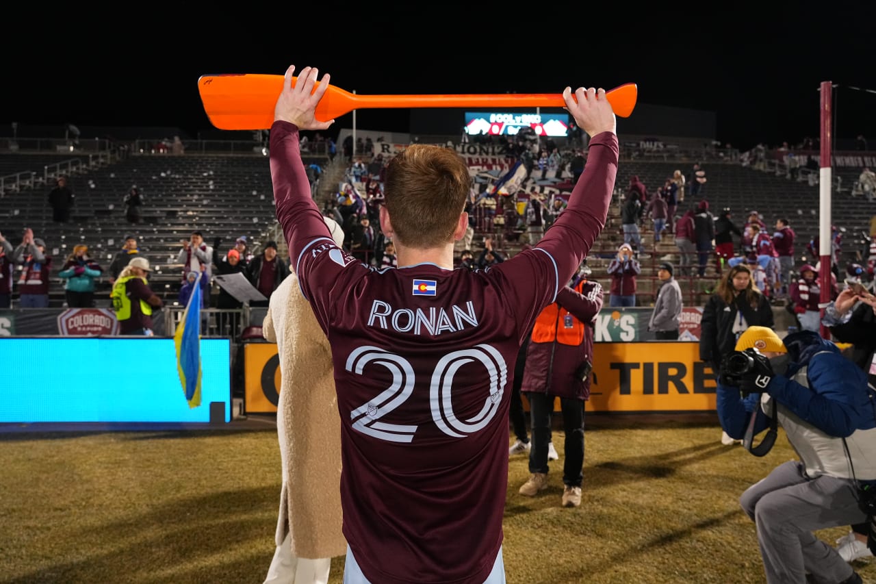 Ronan shows off the supporters' hard work in a gesture of gratitude for his first-ever Man of the Match honor in burgundy.