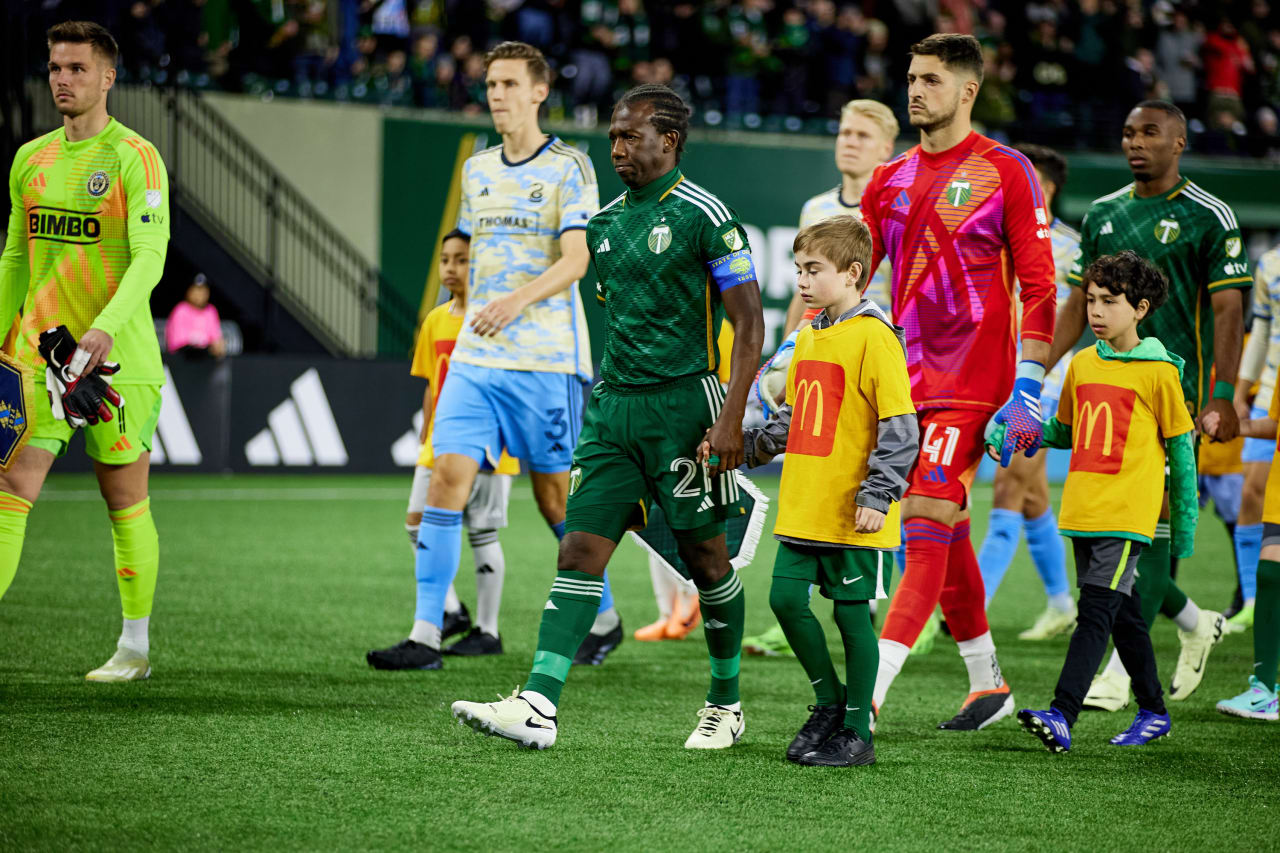 Club captain Diego Chara leads the team onto the field during prematch.