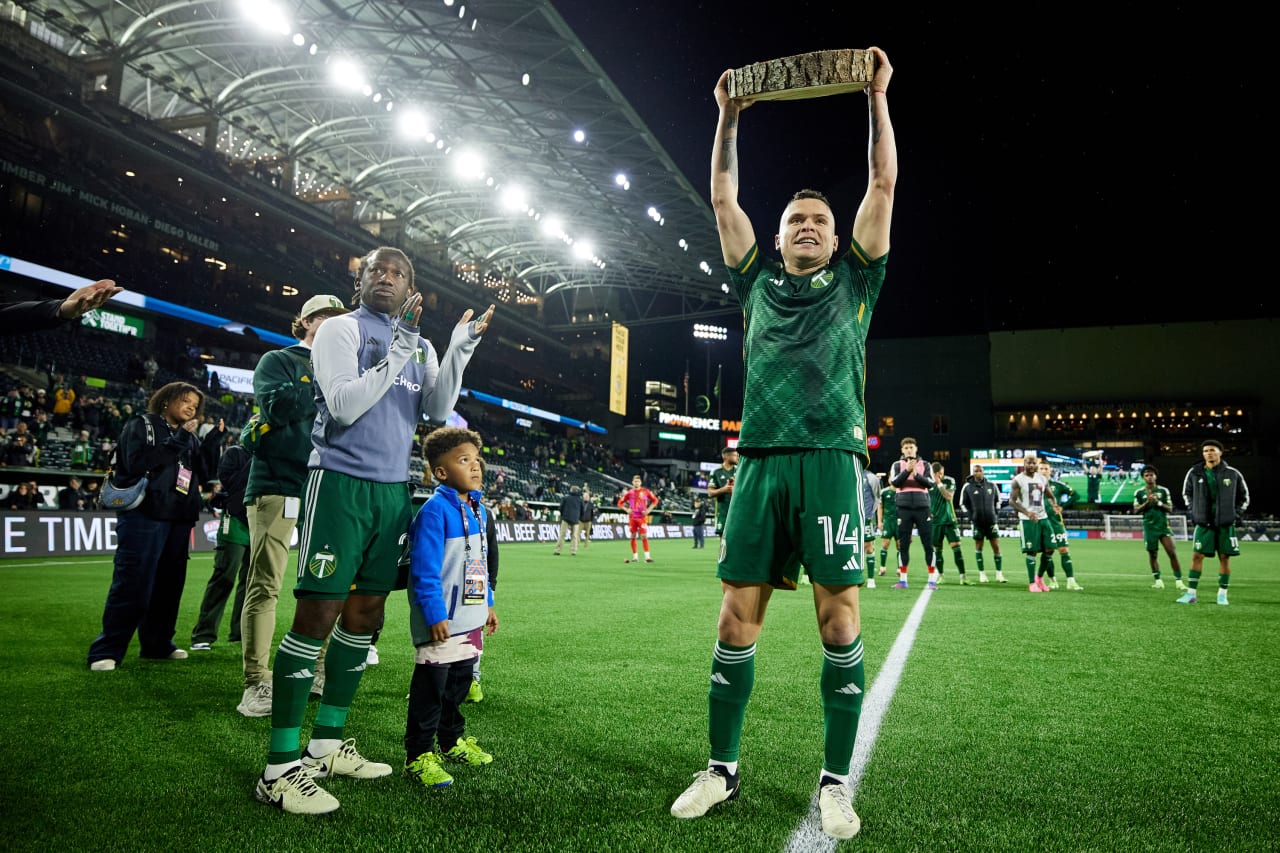 A bittersweet moment – despite loss, designated player/forward Jonathan Rodríguez proudly lifts his first goal log slab at the conclusion of the match.
