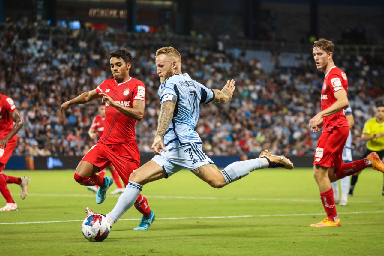 Johnny Russell goes head-to-head with Toluca defenders on Aug. 4.