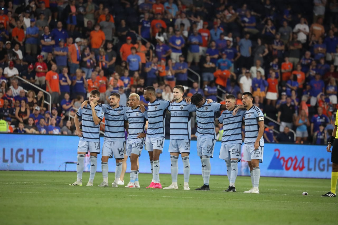 The team watches on as FC Cincinnati takes another penalty kick.