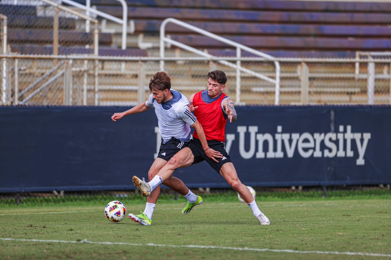 Defender Jake Davis and Forward Marinos Tzionis fight for a ball during preseason training in Miami, Fla.
