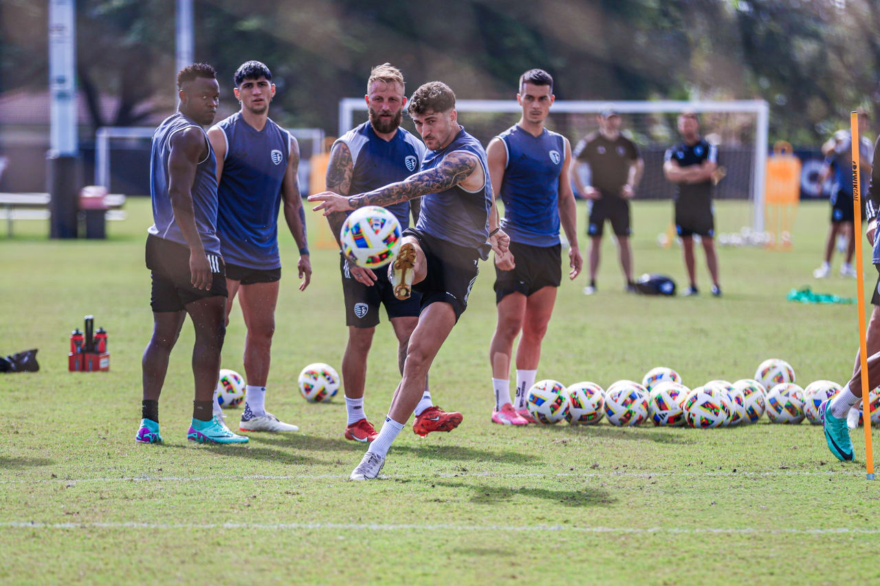 Forward Marinos Tzionis takes a shot at preseason training in Miami, Fla. as teammates Johnny Russel and Erik Thommy look on.
