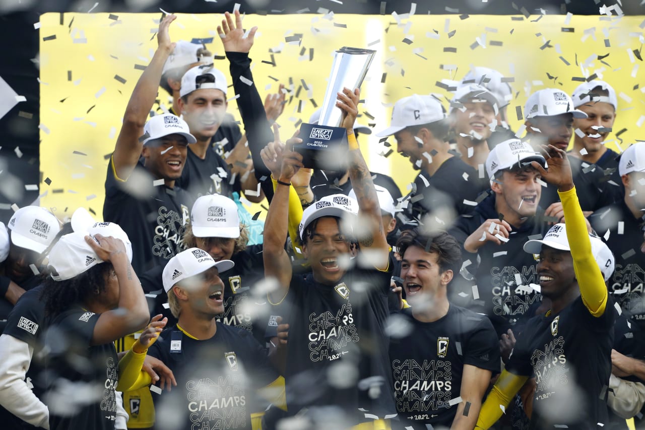 Crew 2 players celebrate with the trophy after winning the MLS NEXT Pro Cup