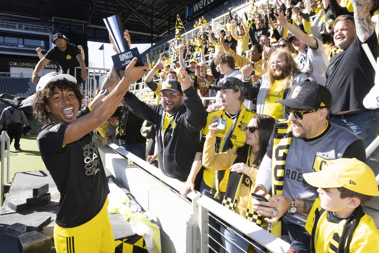 Crew 2 players celebrate with the trophy and fans after winning the MLS NEXT Pro Cup