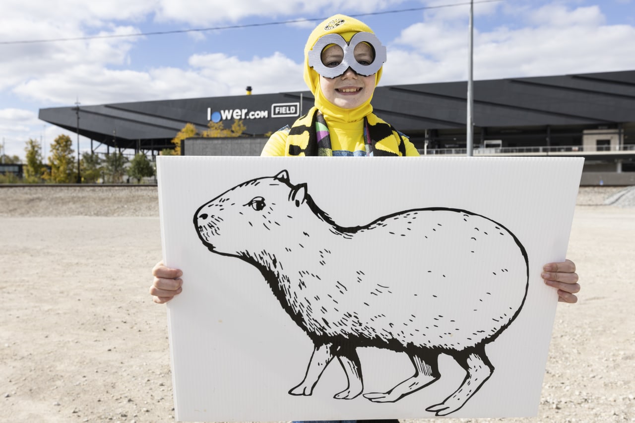 A young Crew 2 fan displays a capybara drawing ahead of the MLS NEXT Pro Cup match