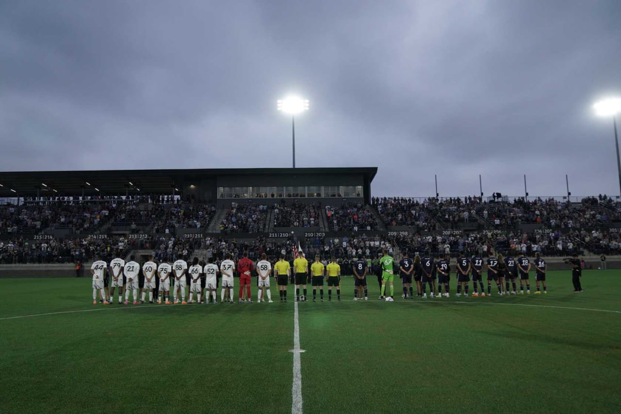 Huntsville City FC and Crown Legacy FC players lineup during the National Anthem before the inaugural game at Wicks Family Field at Joe Davis Stadium