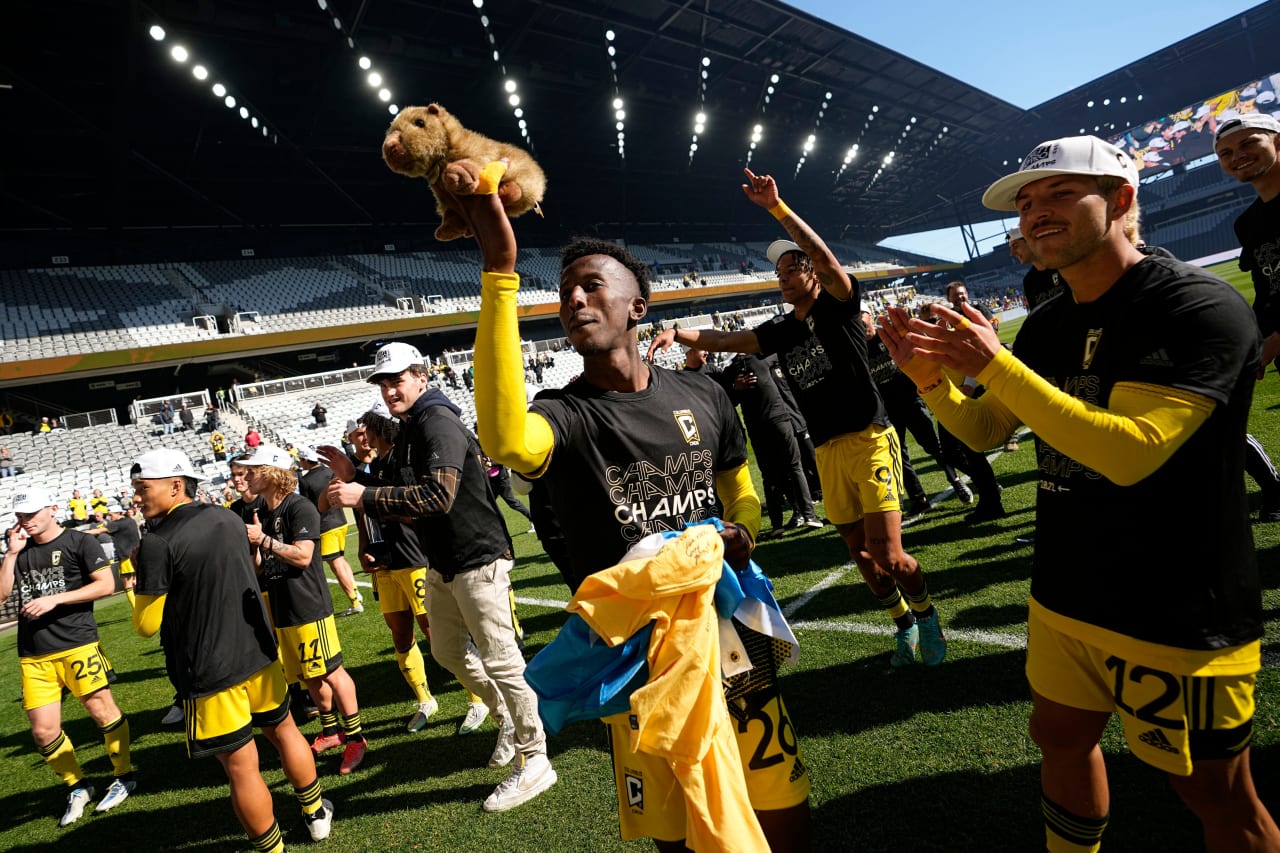 Crew 2 players celebrate with fans and raise a stuffed capybara after winning the MLS NEXT Pro Cup