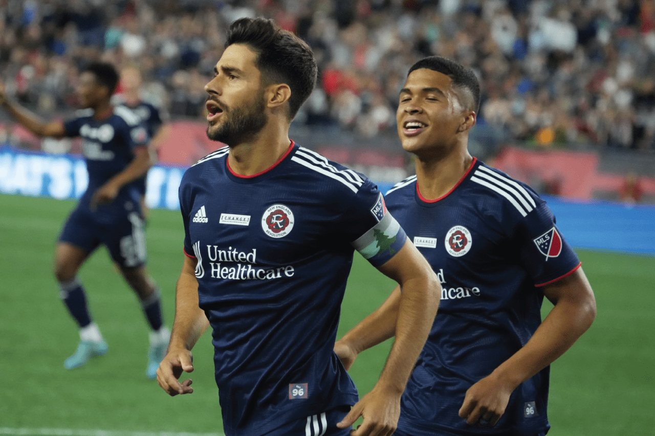 Carles and Damian Rivera celebrate after the goal. 1-0 Revs. Photos By: David Silverman